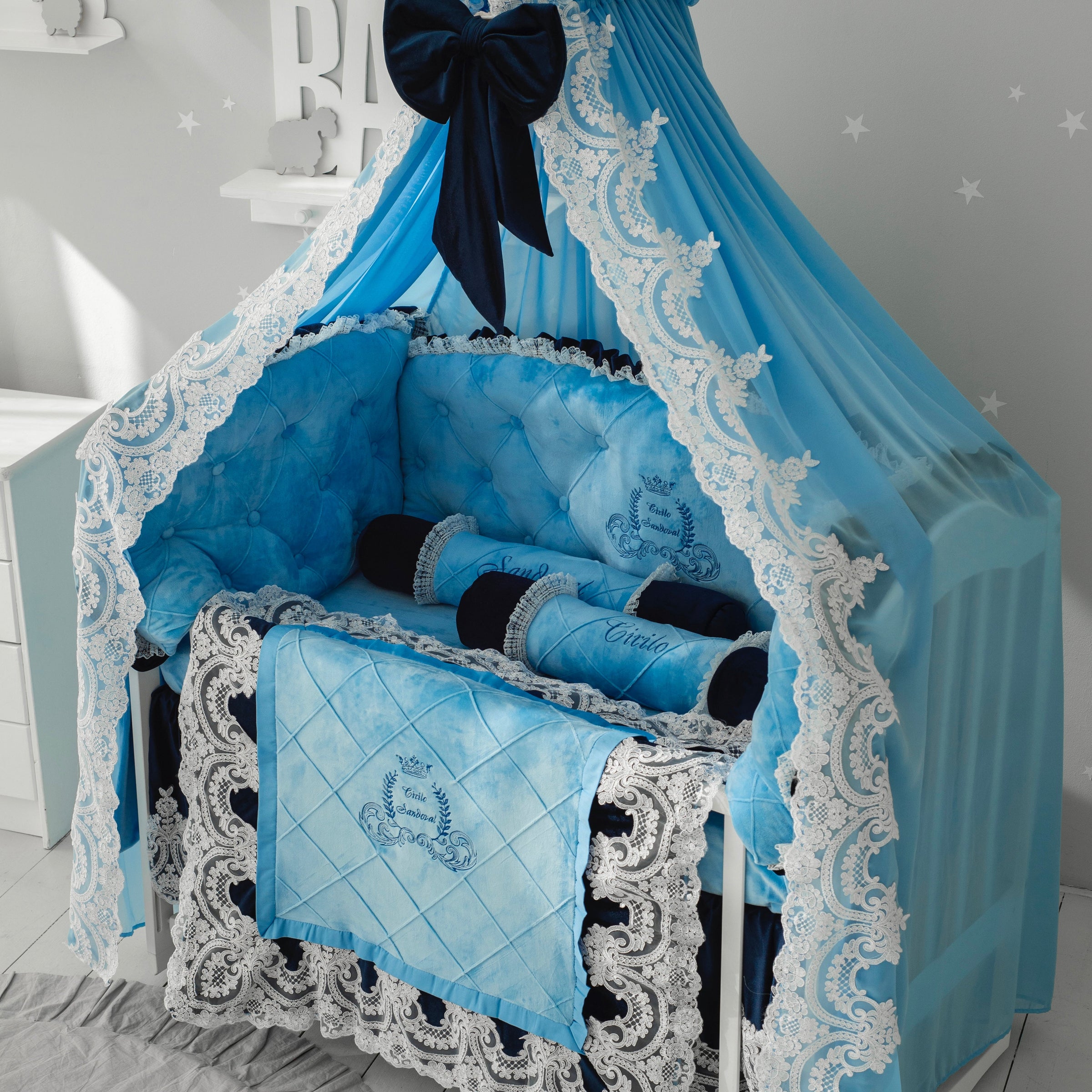 Luxury baby crib bedding set in light blue velour with black satin bedding, ornate lace canopy and embroidered details, elegant nursery crib decor.