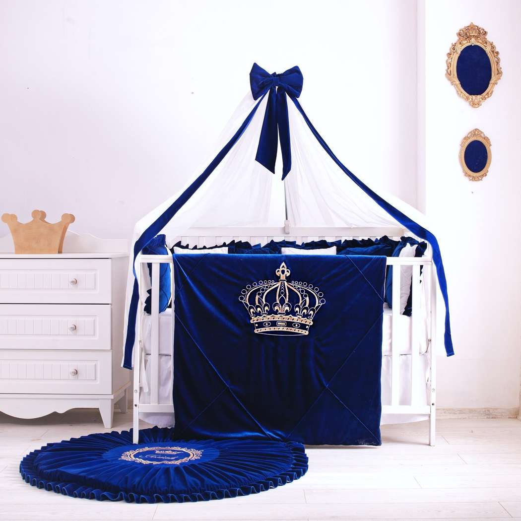 A complete blue crib bedding set featuring multiple shades of blue in a serene room.