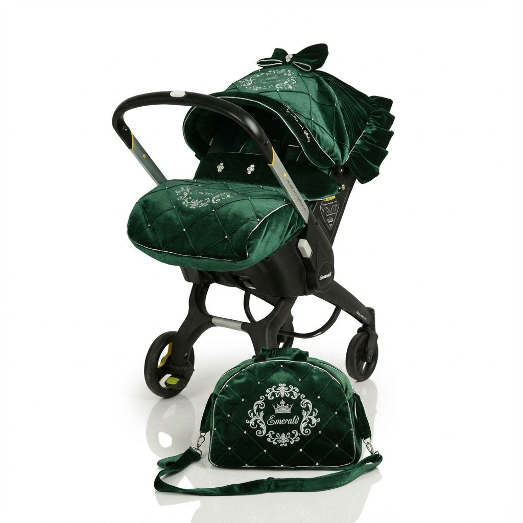 Green infant car seat cover set made of velvet fabric with decorative embroidery, including a matching canopy with bow detail and a coordinated green bag placed in front, shown on a wheeled infant car seat frame against a white background.