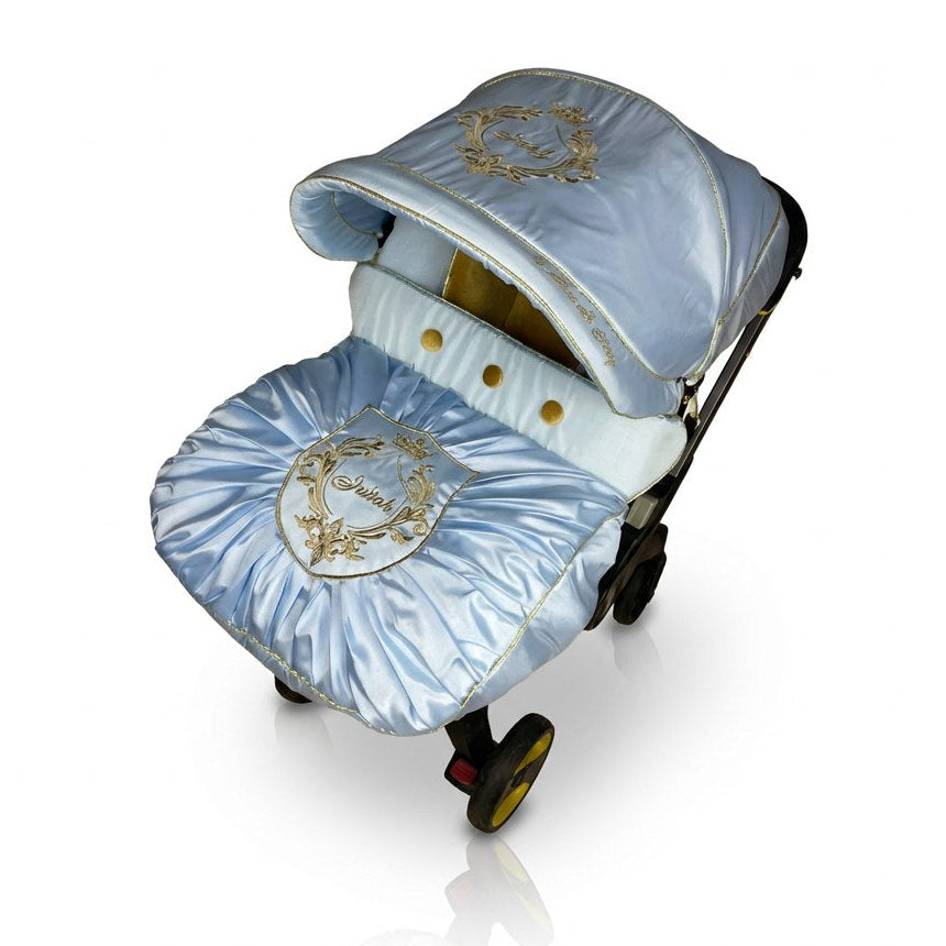 Decorative baby stroller with blue and gold accents on a white background