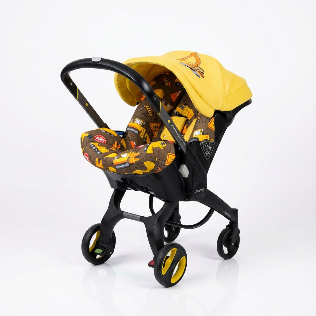 Construction-themed Doona car seat cover set with truck print and yellow canopy featuring embroidered excavator detail.