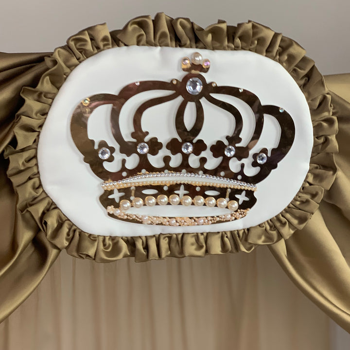 Decorative headboard with a crown design and ruffled edges