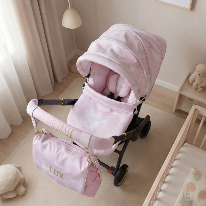 Pink world map cover set on Doona X positioned in the center of a nursery beside a crib, styled with soft toys and warm interior decor.