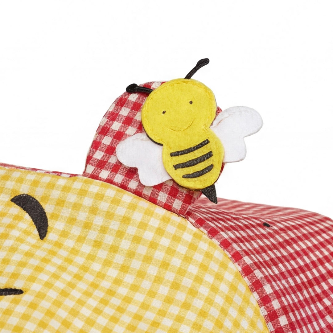 Doona+ canopy ear detail with fabric bee applique, red and yellow gingham design, close-up.