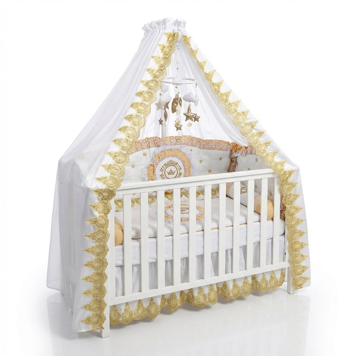 Baby crib with white and gold decorative canopy and bedding on a white background