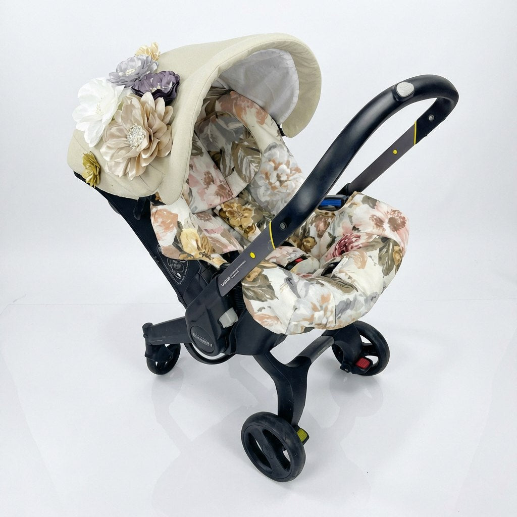 Beige floral Doona car seat cover with 3D fabric flowers on canopy.