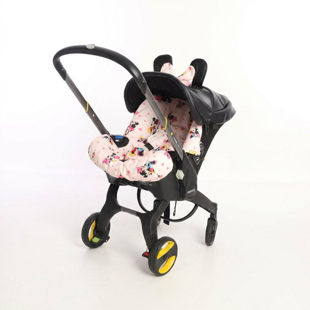 Infant car seat featuring a pink cartoon mouse print cover, black canopy with decorative ears and bow, attached to a compact stroller frame