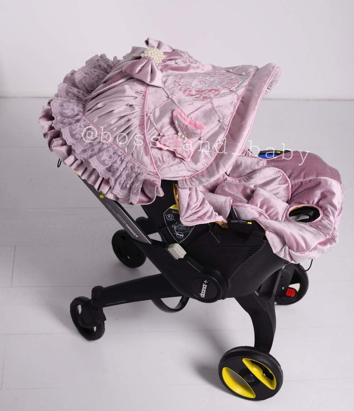 Customizable little girl's Doona stroller car seat with soft, stylish covers & accessories - Perfect for infant comfort, protection, and essential baby gear
