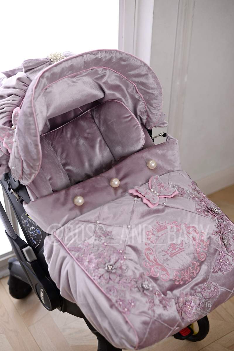 Customizable little girl's Doona stroller car seat with soft, stylish covers & accessories - Perfect for infant comfort, protection, and essential baby gear