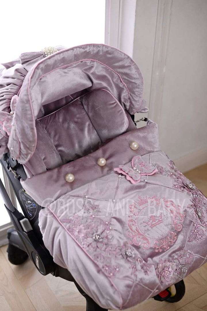Customizable little girl's Doona stroller car seat with soft, stylish covers & accessories - Perfect for infant comfort, protection, and essential baby gear