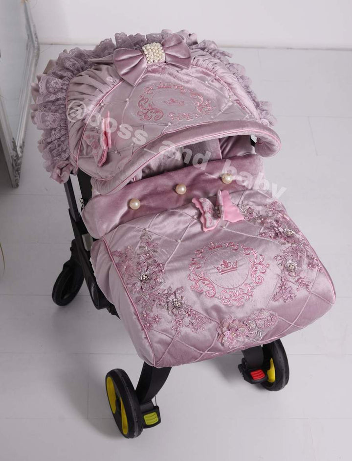 Customizable little girl's Doona stroller car seat with soft, stylish covers & accessories - Perfect for infant comfort, protection, and essential baby gear