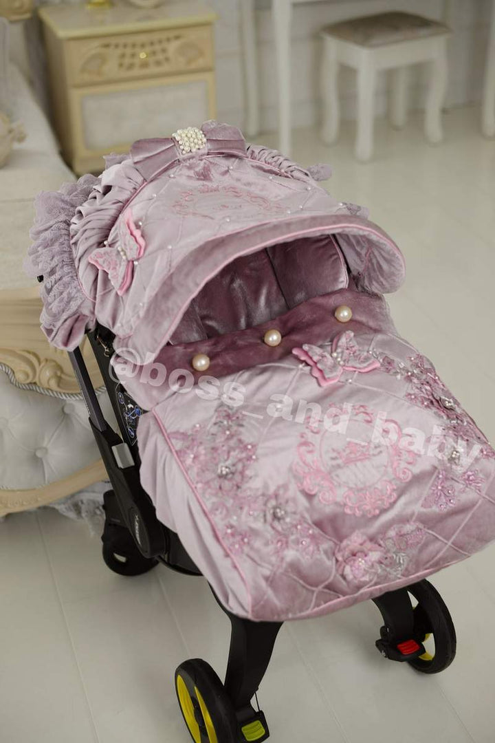 Customizable little girl's Doona stroller car seat with soft, stylish covers & accessories - Perfect for infant comfort, protection, and essential baby gear