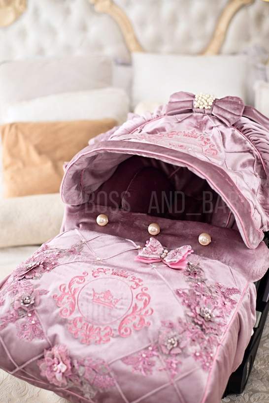 Customizable little girl's Doona stroller car seat with soft, stylish covers & accessories - Perfect for infant comfort, protection, and essential baby gear
