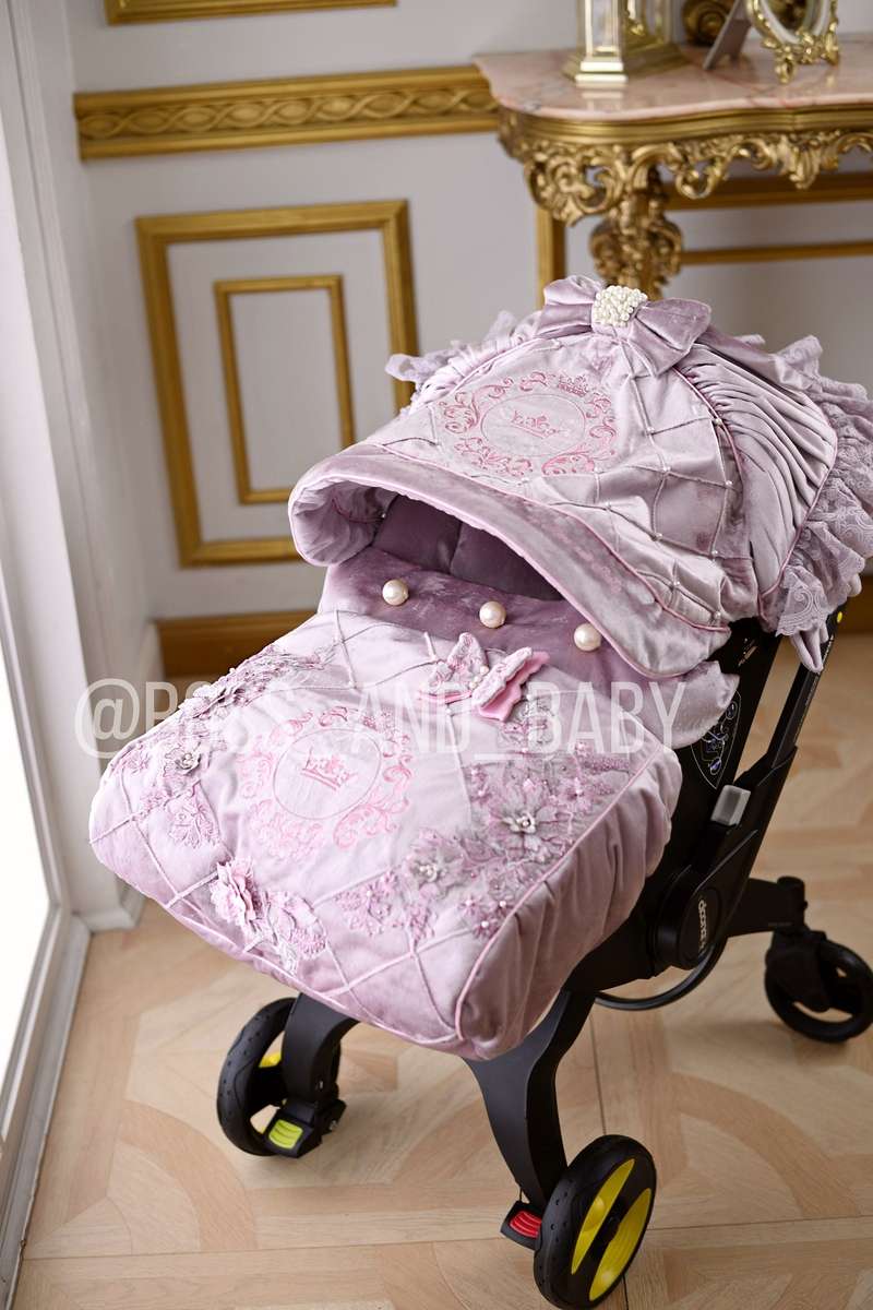 Customizable little girl's Doona stroller car seat with soft, stylish covers & accessories - Perfect for infant comfort, protection, and essential baby gear