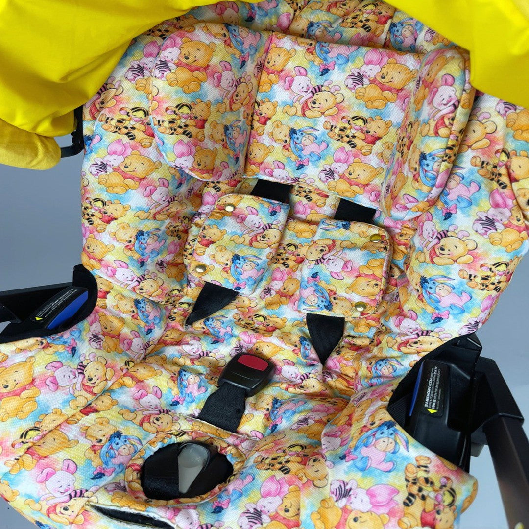 Side view of yellow canopy with bear ears and colorful padded interior